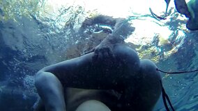 A blonde is getting her pussy rammed under the water in the pool