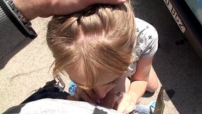A cute thing gets on her knees in the street and then she does a blow job