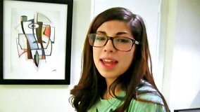 Ava Taylor wears her glasses while she plays with a cock